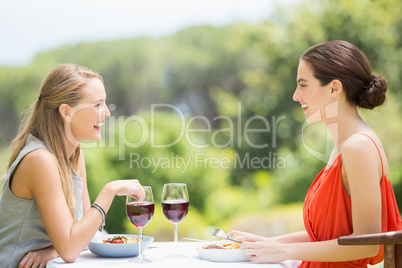 Friends laughing while having food