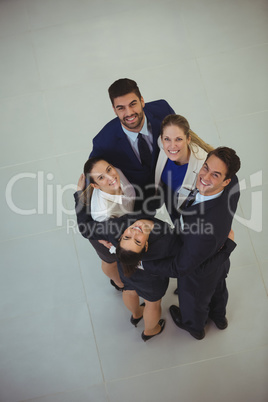 Portrait of businesspeople forming huddle