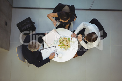 High angle view of businesspeople having breakfast together