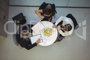 High angle view of businesspeople having breakfast together