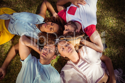 Friends relaxing on grass in park
