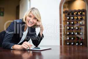 Businesswoman using digital tablet in a restaurant