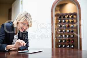 Businesswoman using digital tablet in a restaurant