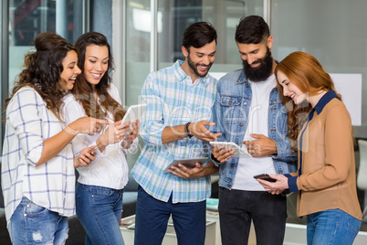 Happy executives using digital tablet and mobile phone