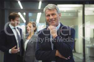 Happy businessman standing in the office