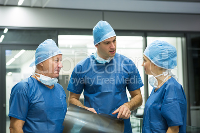 Group of surgeons discussing x-ray