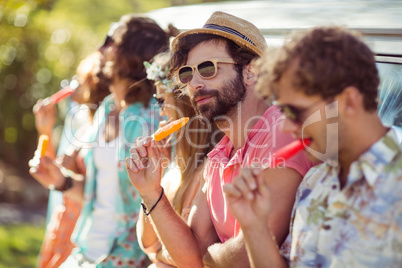 Group of friends eating ice lolly