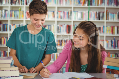 School kids doing homework in library at school