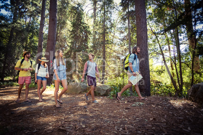 Group of friends walking together in forest