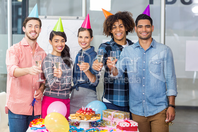 Happy executives holding glasses of champagne