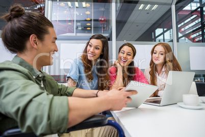 Executives discussing over digital tablet in conference room