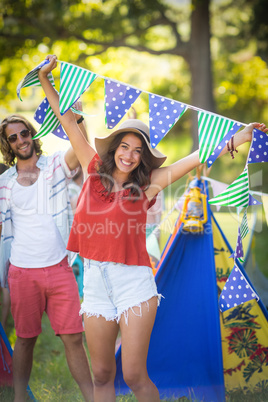 Woman holding bunting at campsite