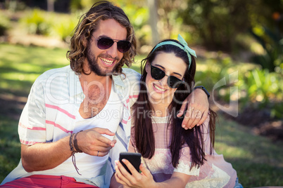 Woman showing mobile phone to man