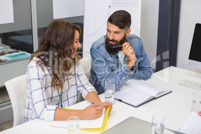 Smiling executives discussing in conference room