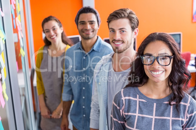 Portrait of smiling executives standing in a row