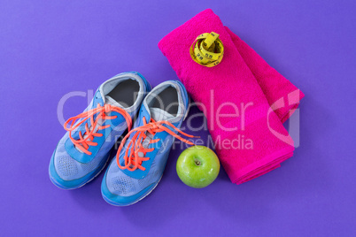 Sneakers, apple, towel and measuring tape