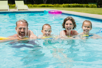 Happy parents and kids in pool