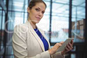 Businesswoman using digital tablet at office