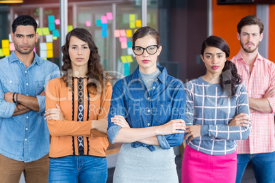 Portrait of executives standing with arms crossed