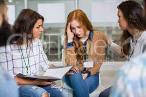 Executives consoling their colleague during presentation