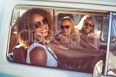 Happy woman driving a campervan