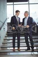 Business executives having a conversation on stairs