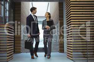 Business executives walking in corridor