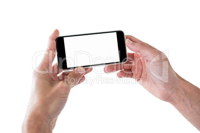Hands holding a mobile phone against white background