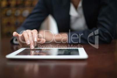 Businesswoman using digital tablet in a restaurant