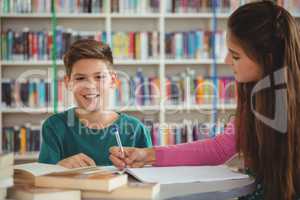 School kids doing homework in library at school