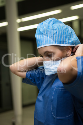 Female surgeon wearing surgical mask