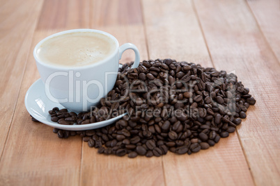 Cup of coffee with roasted coffee beans