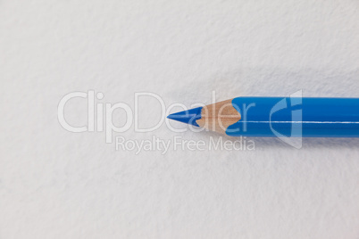 Blue colored pencil on white background