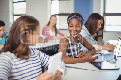 Students interacting with each other in classroom