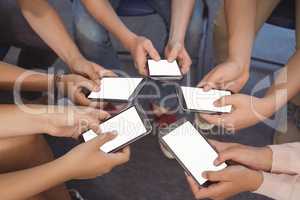Close-up of students holding mobile phone