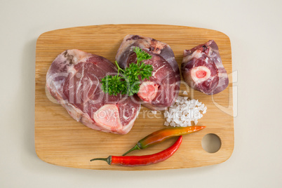 Sirloin chop on wooden board against white background
