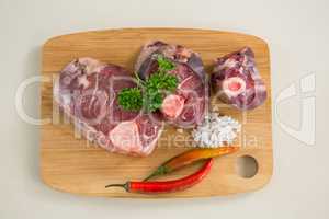 Sirloin chop on wooden board against white background