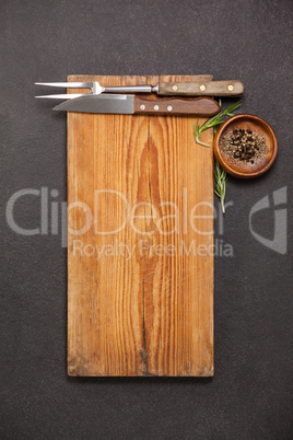Wooden board, knife and fork
