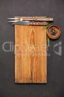 Wooden board, knife and fork