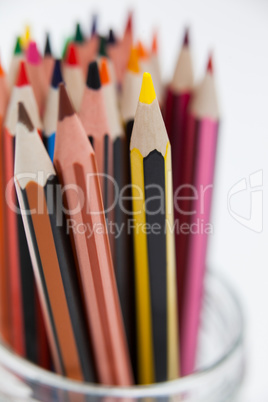 Close-up of colored pencils kept in a glass jar