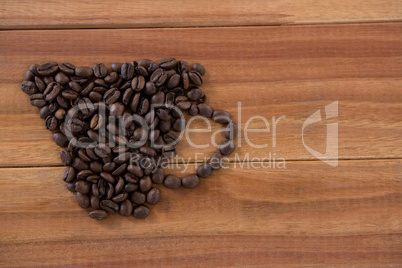 Coffee beans forming shape of cup