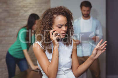 Female executive talking on mobile phone