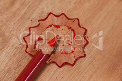 Close-up of red colored pencil with shavings