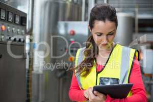 Female factory worker using digital tablet