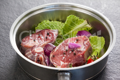 Sirloin chops and ingredients in frying pan