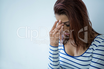 Worried woman with head in hands