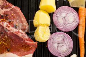 Sirloin chop and ingredients on black grill