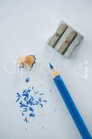 Close-up of blue color pencil with pencil shaving and sharpener