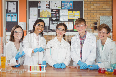 Portrait of school kids doing a chemical experiment in laboratory