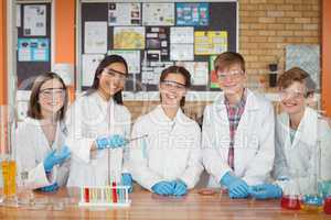 Portrait of school kids doing a chemical experiment in laboratory